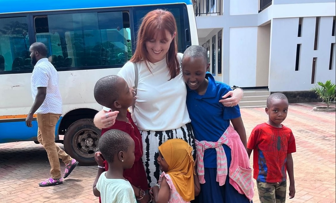 Abby hugging children at Kijana Kwanza