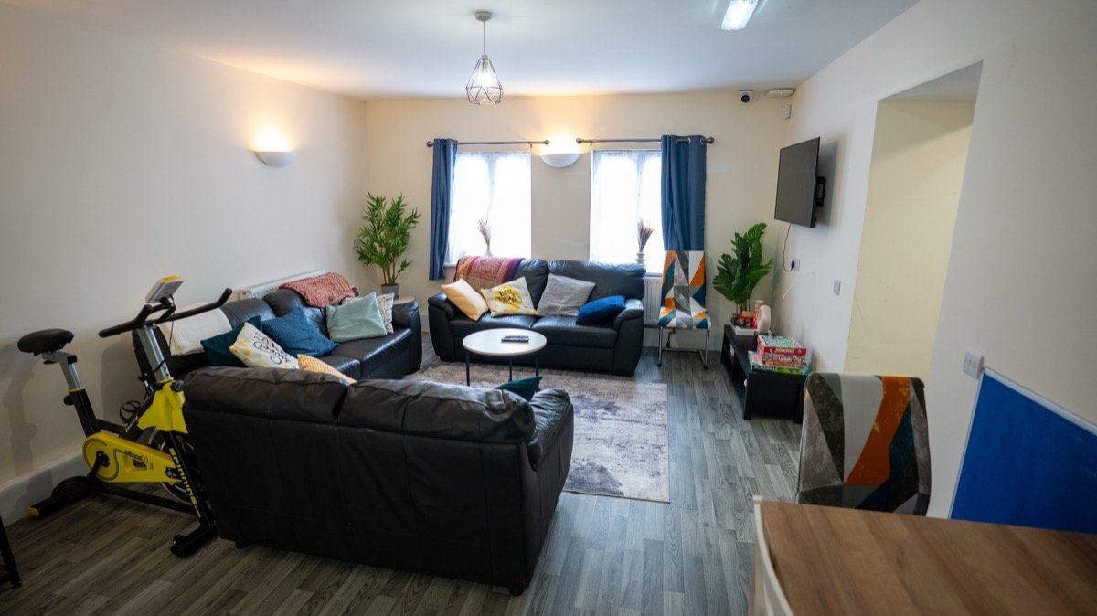 Communal lounge with smart TV and dining area at The Forge